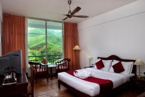 Postel nebo postele na pokoji v ubytování Hotel C7 Munnar + 32 fotografií
