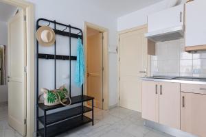 a kitchen with white cabinets and a black shelf at Sandra Amadores in Puerto Rico de Gran Canaria