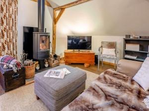 a living room with a couch and a wood stove at 1 Bed in Loxwood 90733 in Loxwood