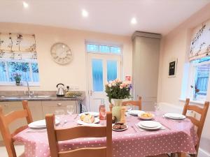 uma cozinha com uma mesa com uma toalha de mesa rosa em 3 Bed in Matlock 90663 em Matlock