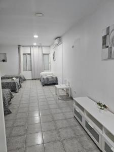 una habitación con 2 camas y una habitación con 2 mesas en MHrosa, en Valencia