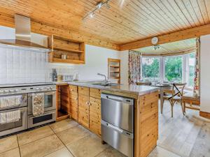 a kitchen with wooden walls and a wooden ceiling at 5 Bed in Dunkeld 90585 in Dunkeld