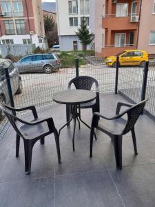 two chairs and a table and a table and chairs at APARTMANS AJAN OHRID in Ohrid