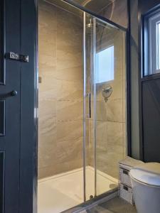 a shower with a glass door in a bathroom at City Centre Bolt Hole - Exeter in Exeter