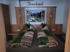two beds in a room with a window at Saumerhof in Schladming