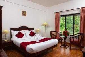 Postel nebo postele na pokoji v ubytování Hotel C7 Munnar
