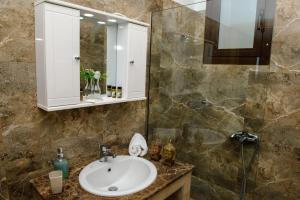 a bathroom with a sink and a mirror at Blue Bay Villas , First Floor in Archangelos +34 photos