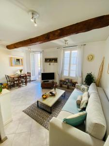 a living room with a couch and a table at Pimms Apartment in Antibes