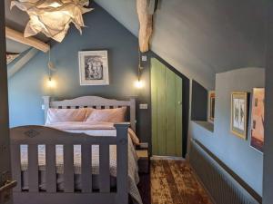 a bedroom with a bed and a green door at Stylish 3 bed Cotswold cottage with stunning views in Cheltenham
