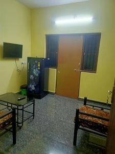 a room with a large door and a table and a room with a coffee table at Shanaya Holiday Apartment in Benaulim