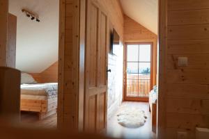 a bedroom with a bed and a door with a window at Steindl Hütte in Deutschfeistritz