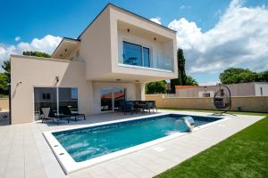 uma villa com uma piscina e uma casa em Villa Paula em Pula