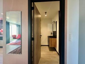 a hallway with a door leading to a room at Rêve Perdu / studio DJ in Bruges +2 photos