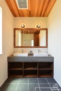 a bathroom with a sink and a mirror at The Lake House 野尻湖 in Shinano