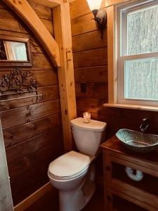 a wooden bathroom with a toilet and a sink at The Treehouse of The Dragon in Ioannina