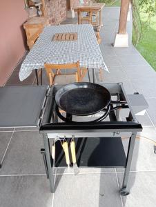a grill with a pan on top of it on a patio at El Astial 