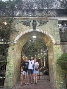 a group of people standing in front of a gate at HELLO VILLA & SPA in Hue