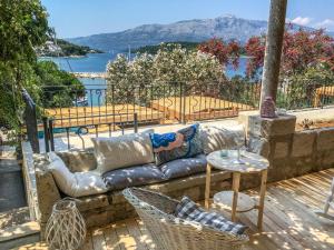 a person laying on a couch on a patio at ECO Aparthotel The Dreamers's Club in Lumbarda
