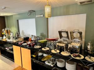 a buffet line with plates and dishes on display at Shatha Abha Furnished Units in Abha