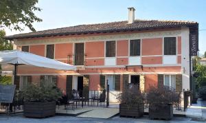 un edificio con una mesa y sillas delante de él en i Torretti Locazione Turistica, Ristorante, Lounge Bar, en Asolo