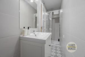 a white bathroom with a sink and a shower at Stylish Loft with 2 beedrooms en el Centro - La Latina in Madrid