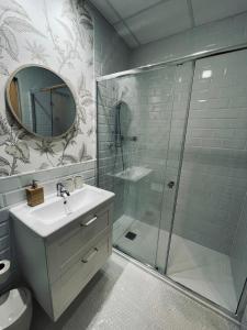 a bathroom with a shower and a sink and a mirror at New Stylish Apt 5pax en la Plaza de Espana in Madrid
