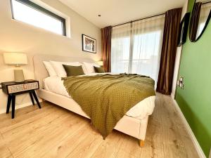 a bedroom with a large bed and a window at The Snug At Pierson House in Plymouth