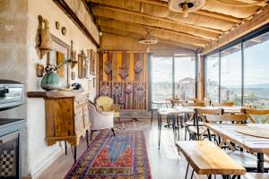 a restaurant with tables and chairs and large windows at Zen Cappadocia in Uchisar