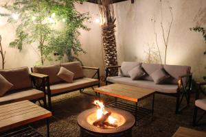 a living room with couches and a fire pit at STAY Villa in Riyadh