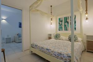 a bedroom with a bed with a canopy at Villa delle Sirene in Porto Cesareo