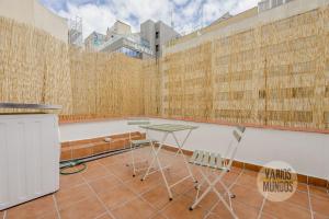 a room with a table and chairs on a balcony at Atico Calle Silva para 3pax con terraza esquina con Gran Via in Madrid