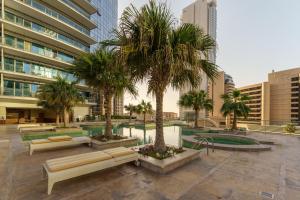 a courtyard with palm trees in front of a building at Lavish Living in Dubai Marina's Finest 2 bedroom in Dubai