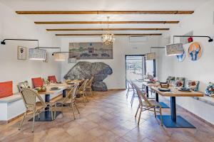 a dining room with wooden tables and chairs at Hospedium Hotel Rural Virgen María in Castilblanco de los Arroyos