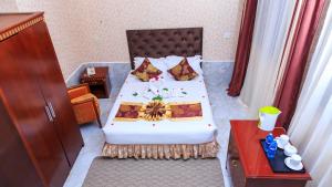 Una cama o camas en una habitación de Easy Hotel Kenya