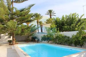 a swimming pool in front of a house with trees at Llevantada - Casa en Poblenou del Delta con piscina privada y barbacoa in El Poblenou del Delta