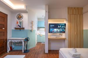 a room with a television and a table in a room at La salle Avenue Condo Residences in Bacolod
