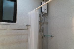 a shower with a shower curtain in a bathroom at La salle Avenue Condo Residences in Bacolod +39 photos