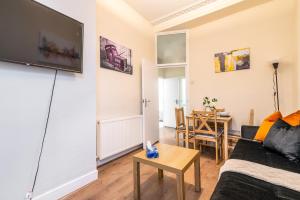 a living room with a couch and a table at LiveStay Cozy One Bedroom Apartment in Brixton in London