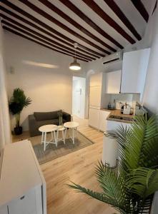 a kitchen and living room with a couch and a table at Centrico Apt 7pax en Anton Martin-Centro in Madrid