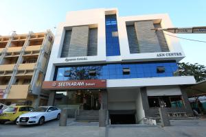 a white car parked in front of a building at Fressotel Seetharam in Coimbatore