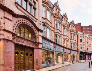 a row of buildings on a city street at City Centre - New Street in Birmingham