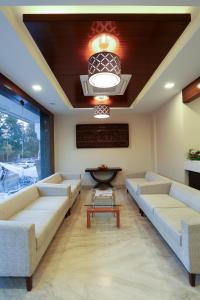 a large living room with couches and a table at Fressotel Seetharam in Coimbatore