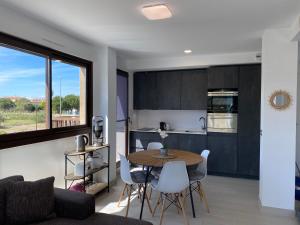 a kitchen and living room with a table and chairs at Las Lomas Denia I Les Deveses in Denia