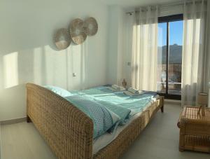 a bedroom with a bed and a large window at Las Lomas Denia I Les Deveses in Denia