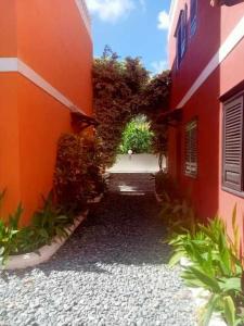 an entrance to an orange building with a driveway at Aldeia Jerome in Paul