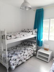 En eller flere senge i et værelse på Bosmar Bosc 5-A