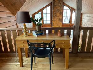 a desk with a lamp and a chair in a room at Idre Mountain Lodges with 11 beds in Idre