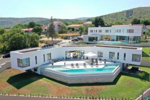 an aerial view of a house with a swimming pool at Luxury Villa Blue with a pool in Zmijavci