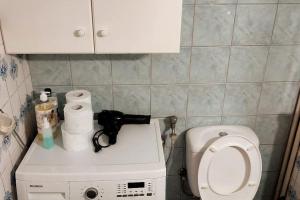 a small bathroom with a toilet and a sink at Christie's Apartment in Agrinion