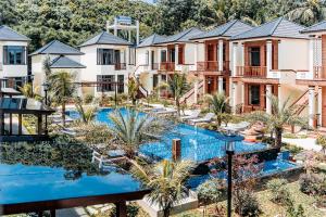 an aerial view of a resort with a pool and palm trees at Palm Bay Resort Phu Quoc in Phú Quốc